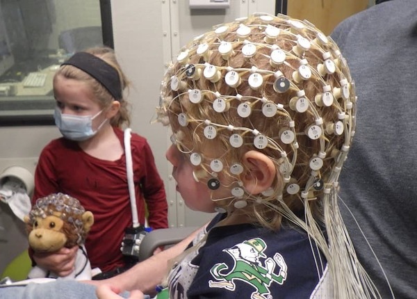 1 Year Old wearing EEG net and Fighting Irish jersey during data collection