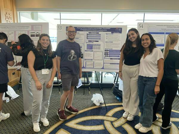 BRAIN Lab research assistants standing in front of poster 