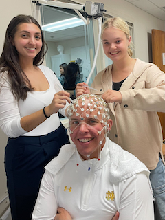 BRAIN Lab Lab Manager and Research assistant seating and scrubbing the research assistant's dad's EEG cap.