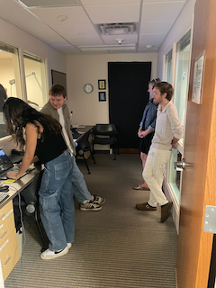 BRAIN Lab Research Assistant setting up the pressMORE task to demostrate for her friends.