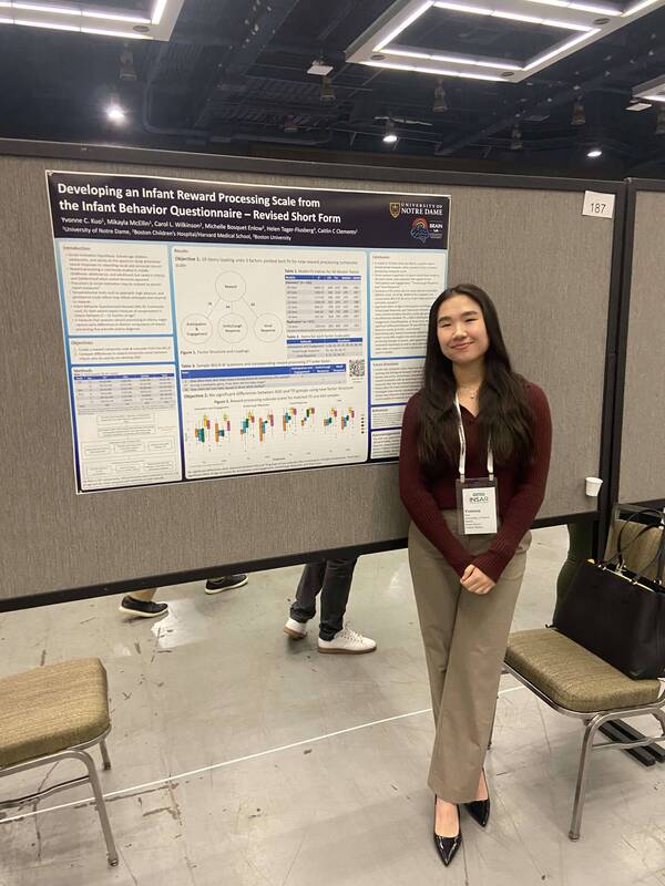 Lab member standing in front of scientific photo